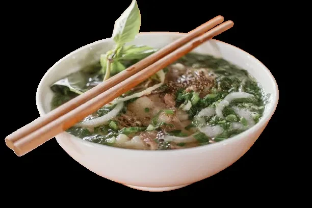 White bowl of Vietnamese pho soup with meat, noodles, basil, chopsticks.