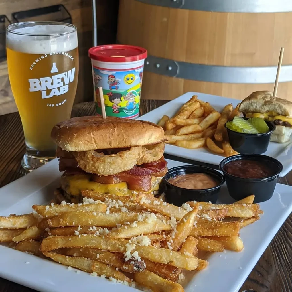 Gourmet burger, parmesan fries, beer, and a Super Mario kids' cup.