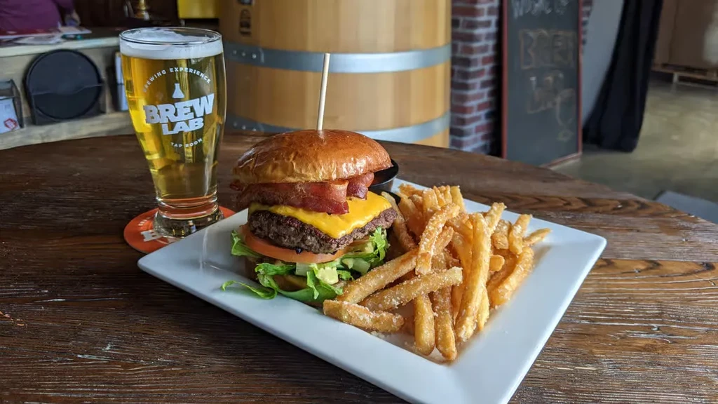 Burger, fries, and Brew Lab lager beer at a taproom.