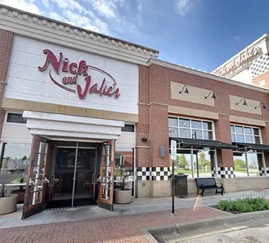 Nick and Jake's restaurant: modern brick exterior, open doors, daytime.