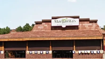 Exterior of Margarita's Restaurant with stylized sign, shingled roof, and brick base.