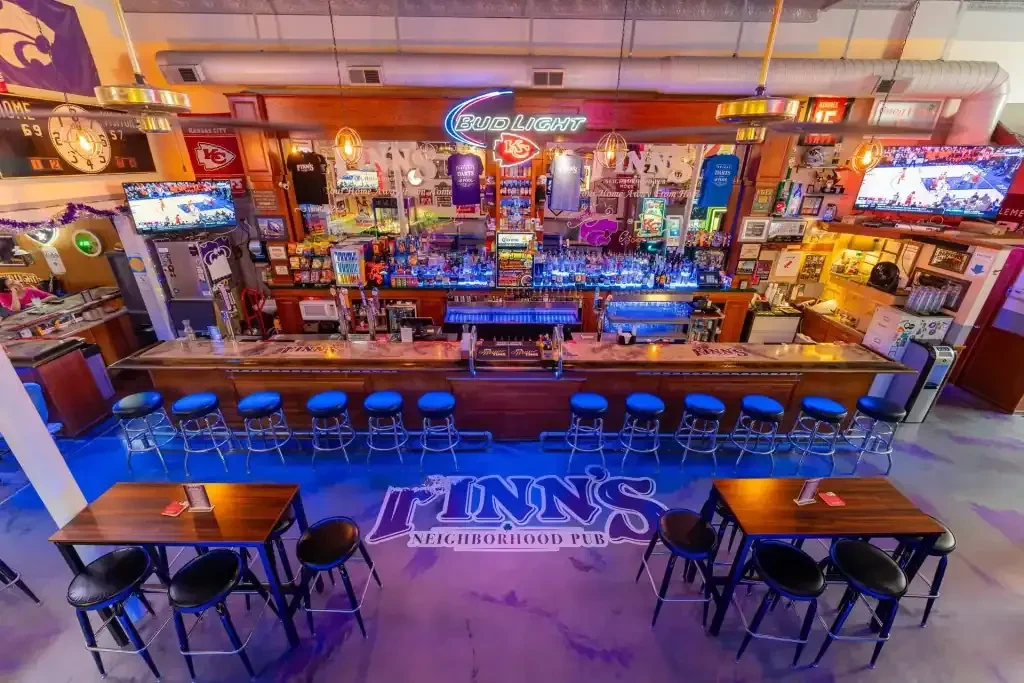 Interior of Finn's sports pub with a long bar and memorabilia.
