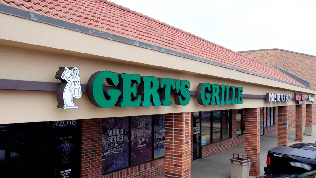 Gert's Grille storefront with prominent sports and beer promotional posters.
