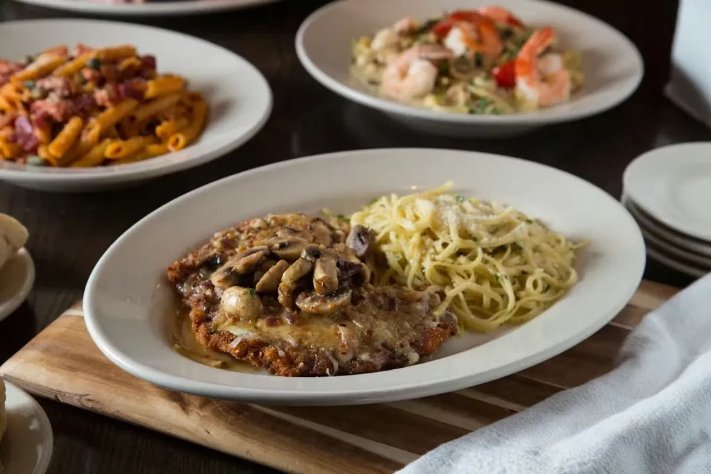 Breaded cutlet, mushroom sauce, and two other pasta dishes.