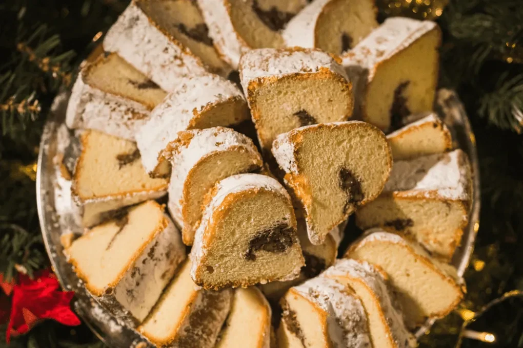 Festive platter of sugared sweet bread slices with swirled filling.