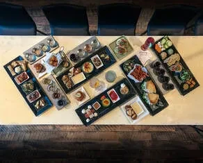 Overhead view: table covered with various food and drink platters.