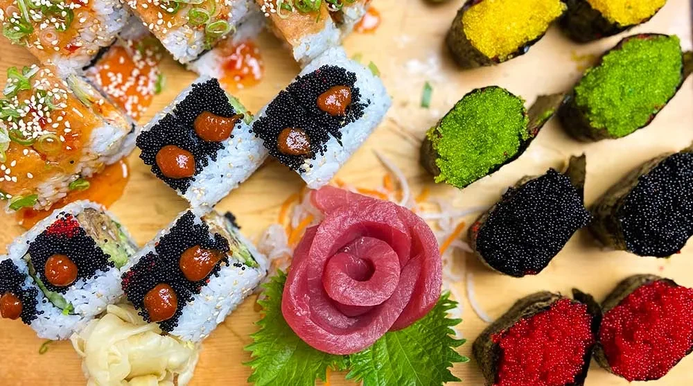 Artfully presented sushi and sashimi platter on wood.
