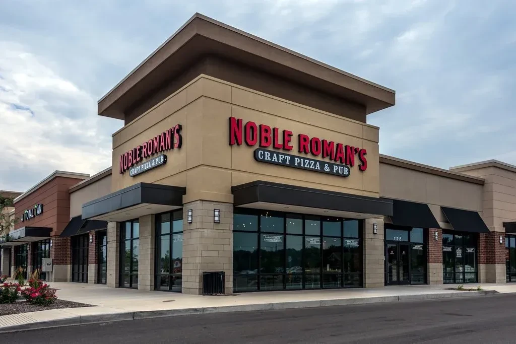 Modern building exterior of Noble Roman's Craft Pizza & Pub.