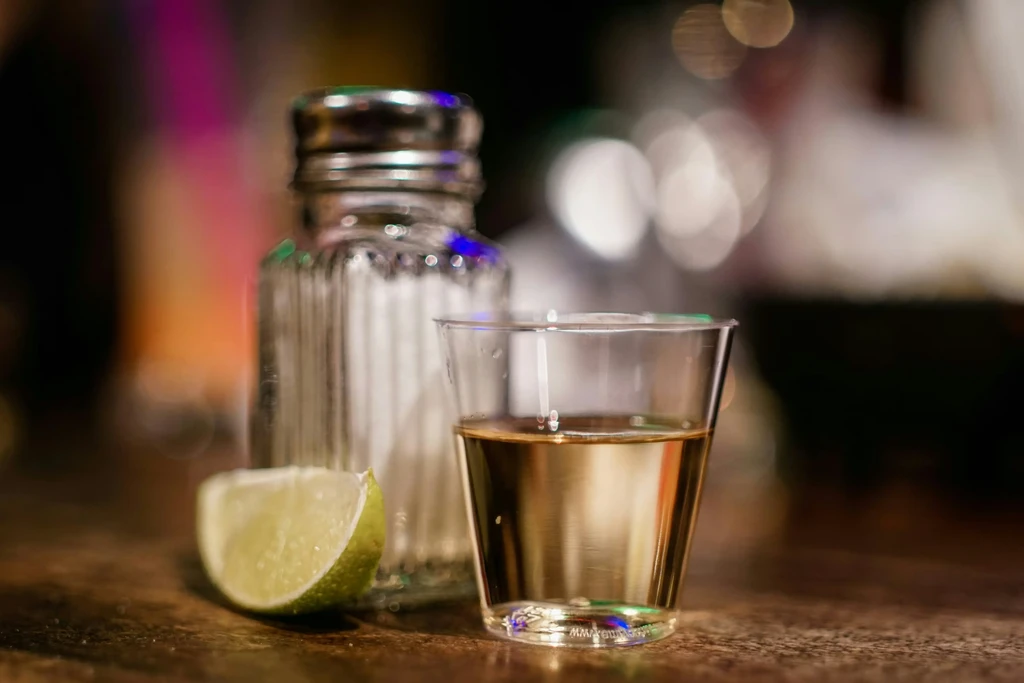 Close-up: A single tequila shot with salt and lime.