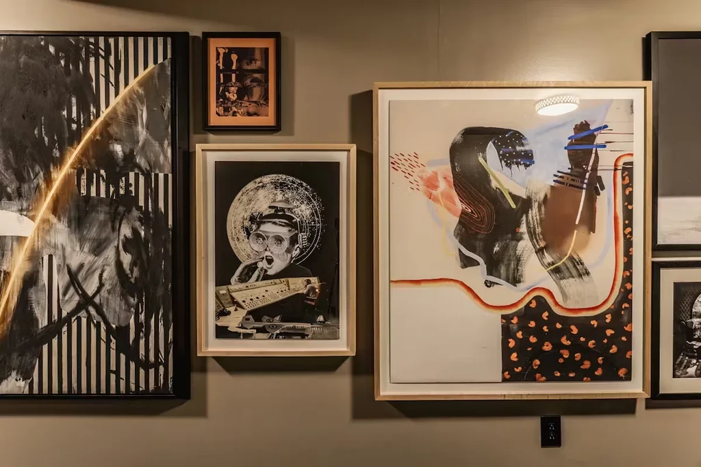 Five framed abstract and collage artworks displayed on a neutral wall.