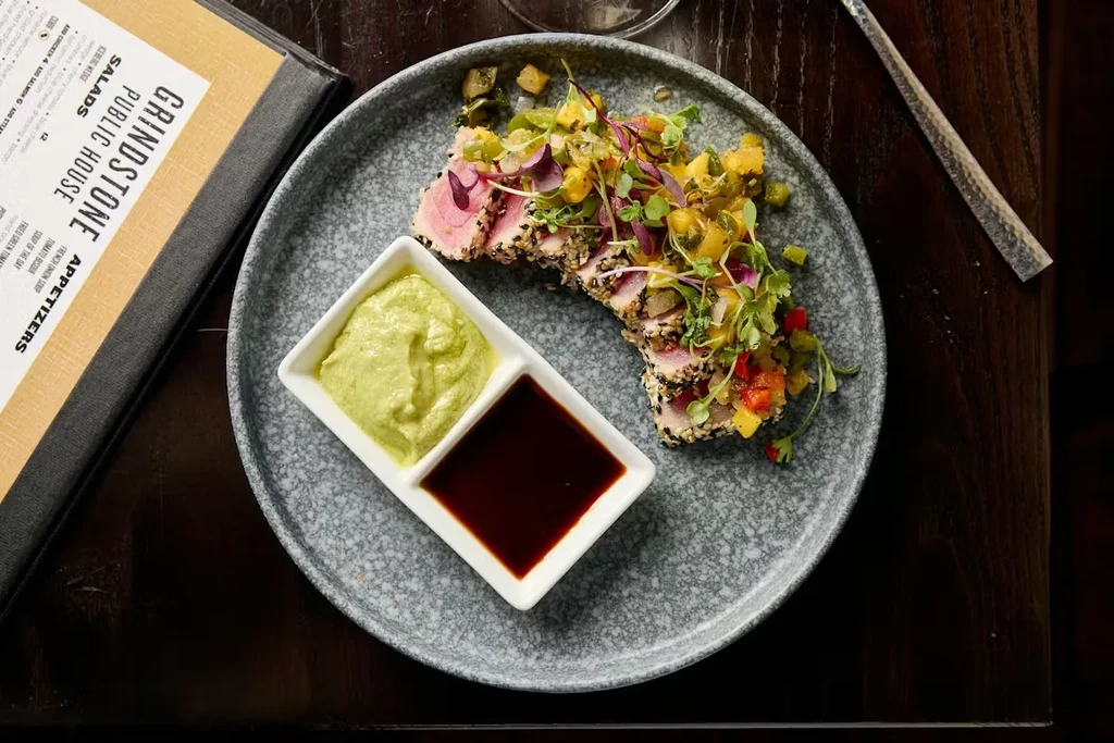 Seared sesame tuna with colorful mango relish, dipping sauces, and menu.