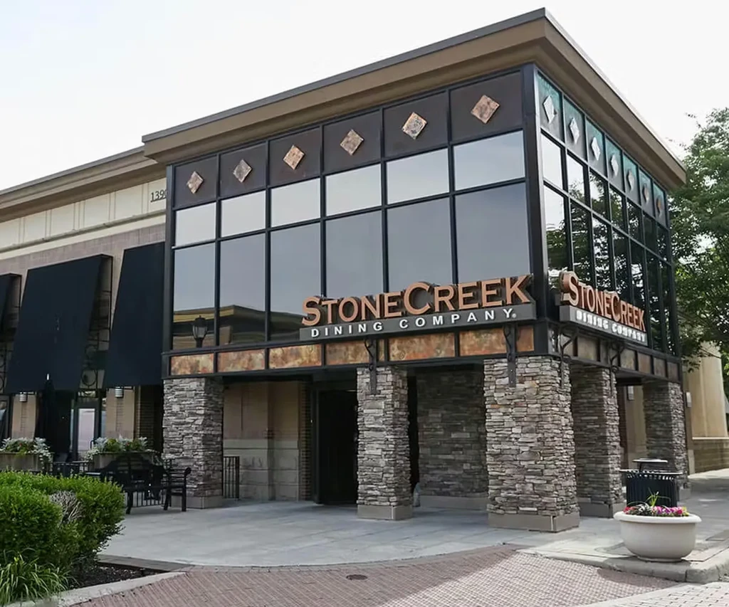 Modern Stone Creek Dining Company building: stacked stone, glass, and copper.