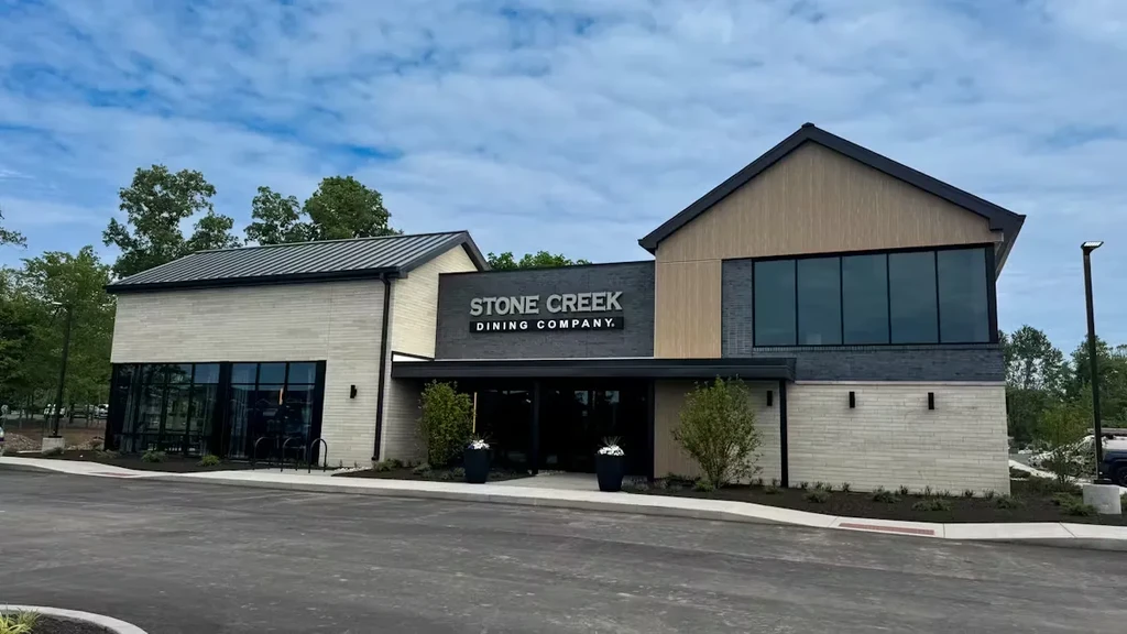 Modern Stone Creek Dining Company restaurant exterior with stone, brick, and wood.