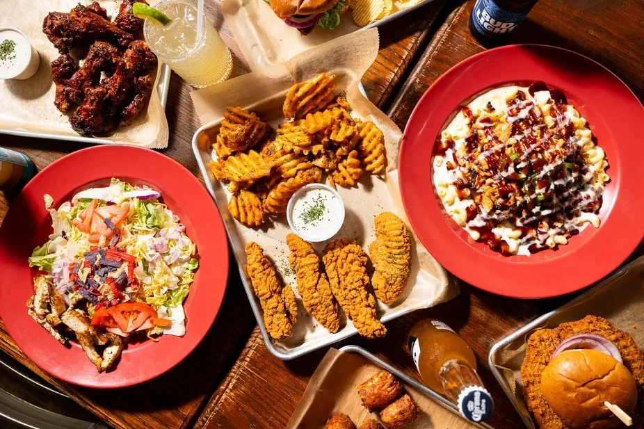 Overhead view of a generous spread of American comfort food and drinks.