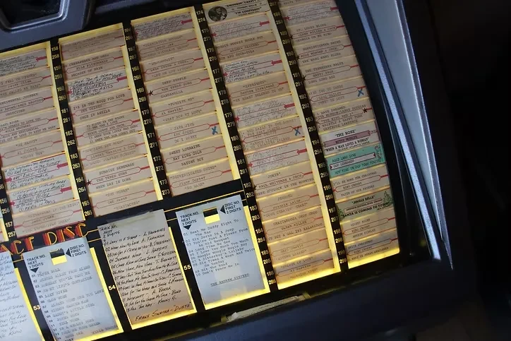 Illuminated song selection panel of a classic vintage jukebox.