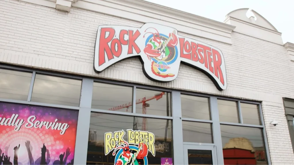 White brick 'Rock Lobster' restaurant, large sign with guitar-playing lobster.