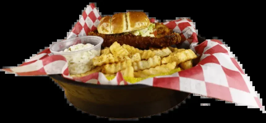 Fried chicken sandwich, crinkle-cut fries, and coleslaw in a black bowl.
