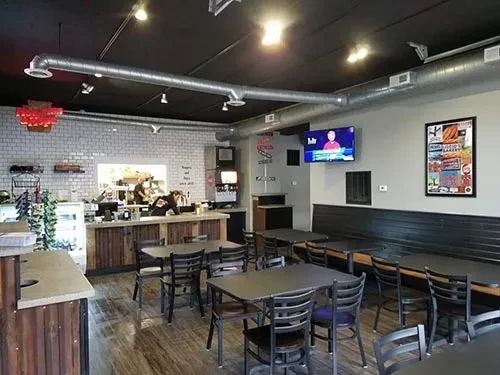Wide view of a modern casual restaurant dining area and service counter.
