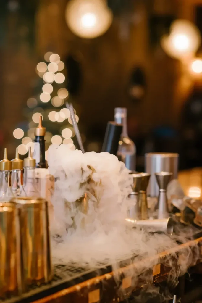 Smoking drink on a bar with blurred festive lights.