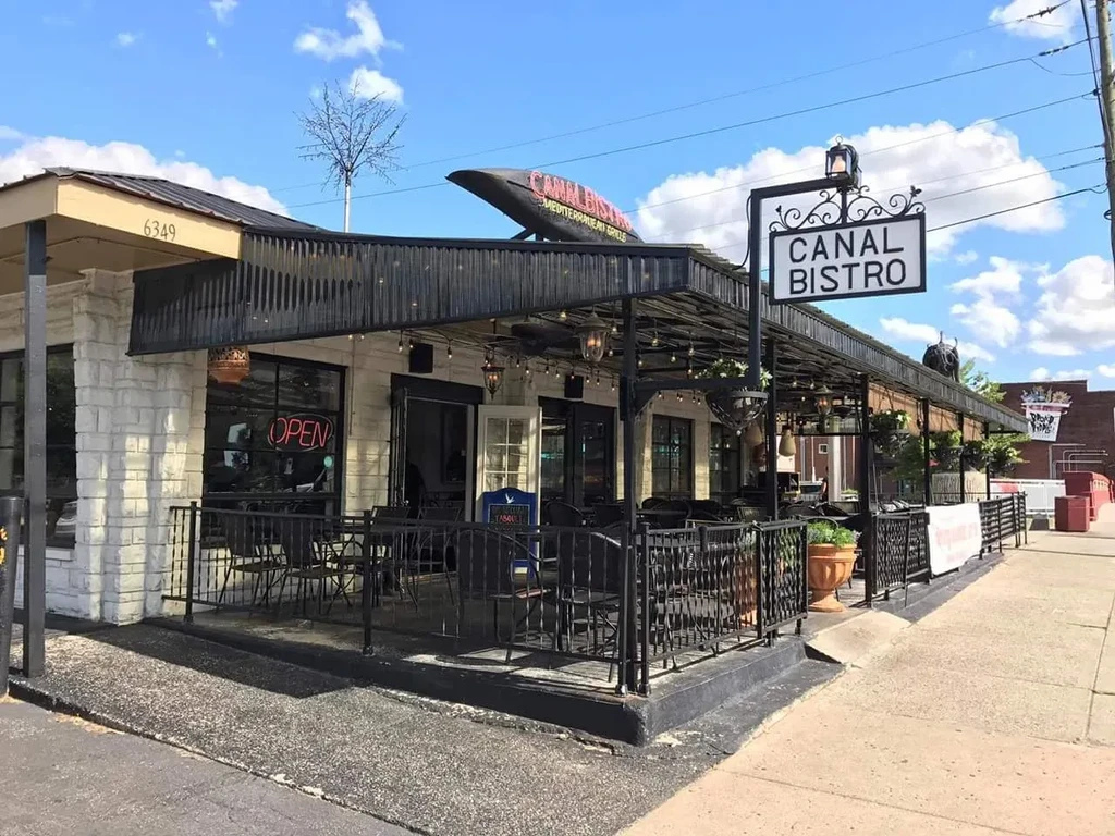 Canal Bistro restaurant exterior with black awning and patio seating.