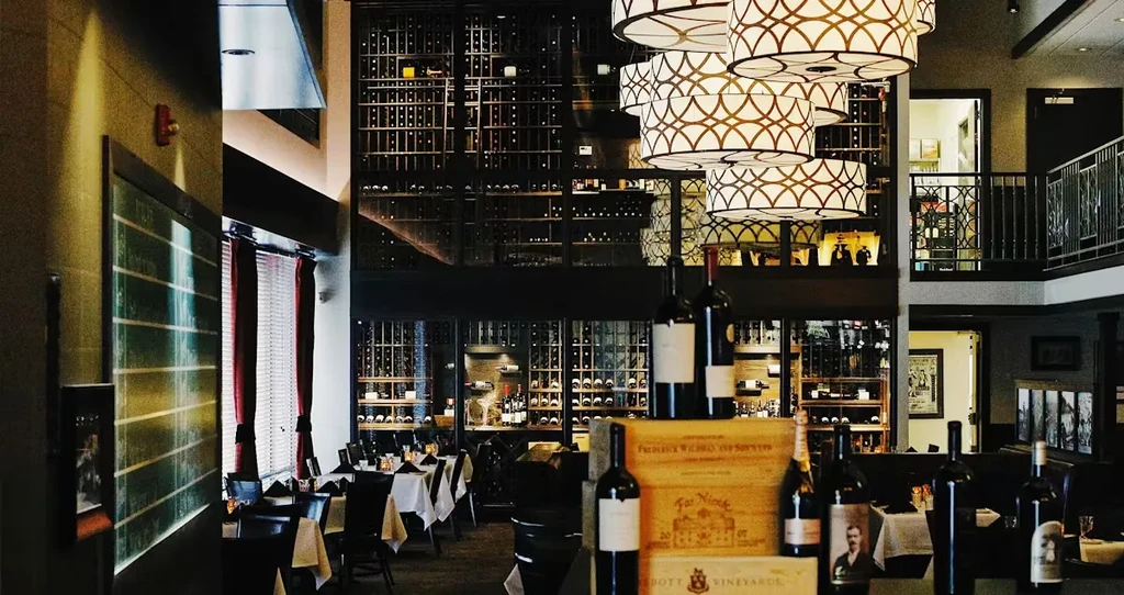 Elegant wine bar with a towering multi-level wine bottle display.