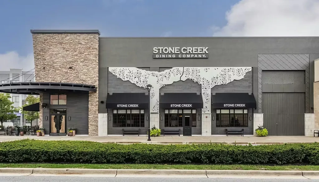 Modern Stone Creek Dining Company exterior with decorative facade cutouts.