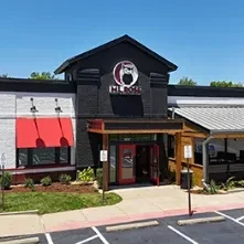 Mr. Bigg restaurant exterior: dark facade, prominent signage, patio, parking lot.