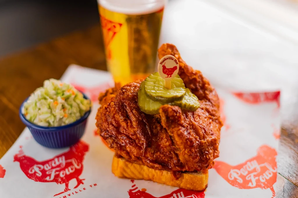 Party Fowl Nashville hot chicken sandwich with pickles and coleslaw.