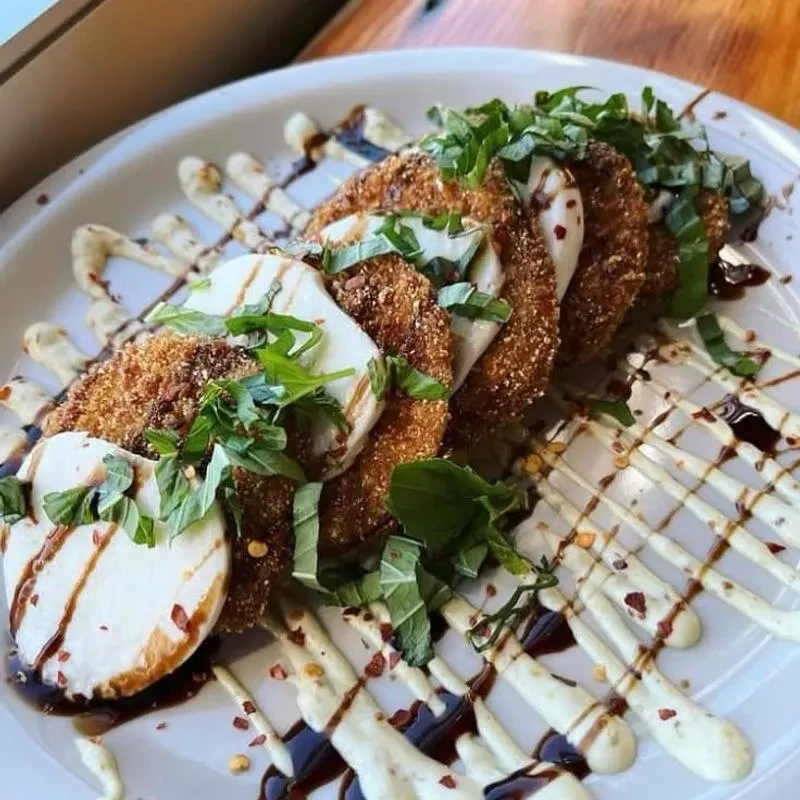 Fried eggplant parmesan with mozzarella, herbs, balsamic, and white sauce.