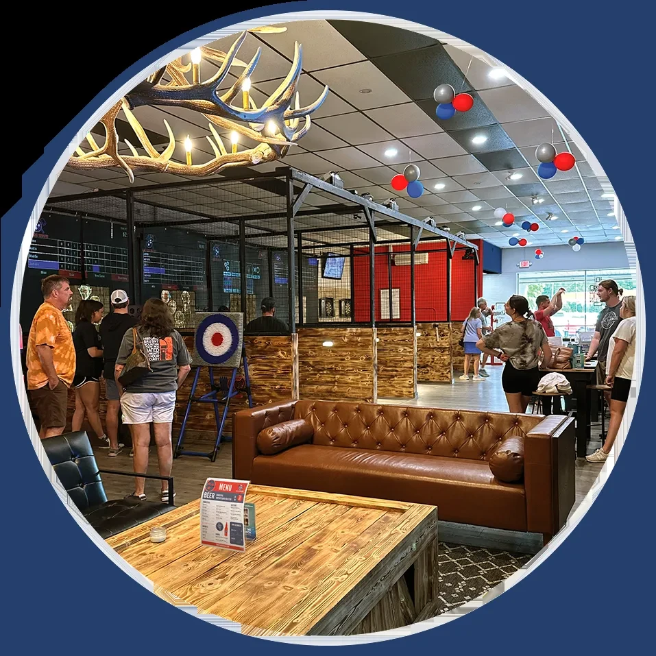 Festive axe-throwing venue interior with lounge seating and targets.