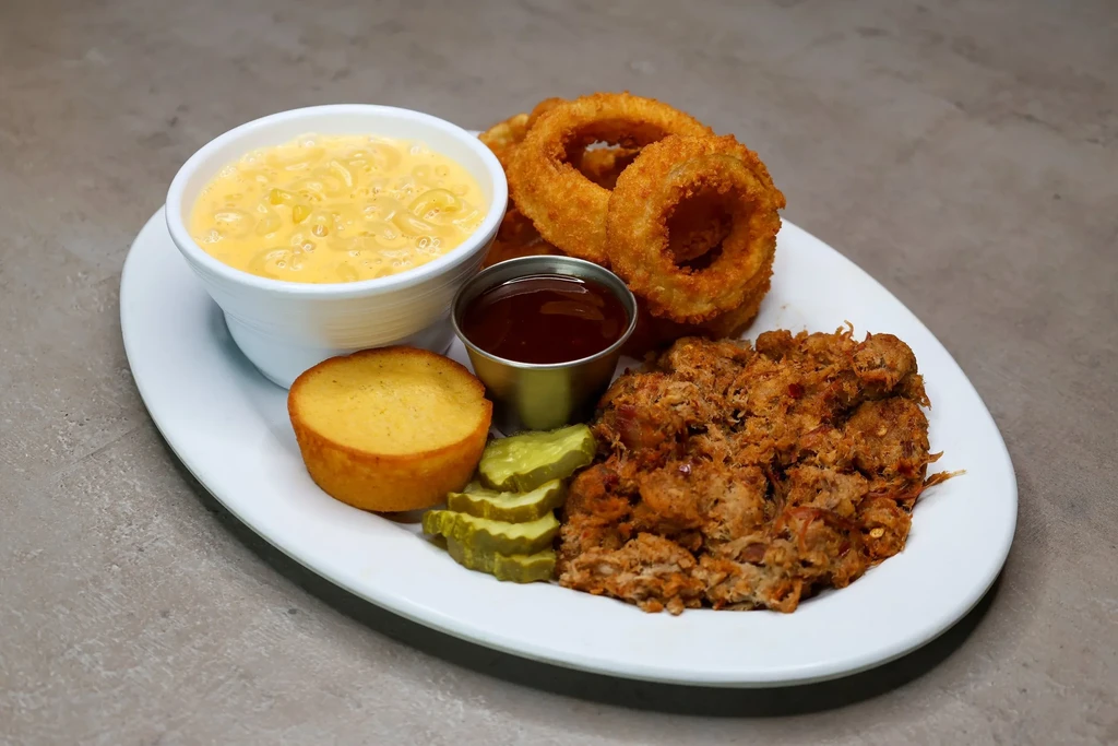 Pulled pork plate with mac and cheese, cornbread, onion rings, pickles.