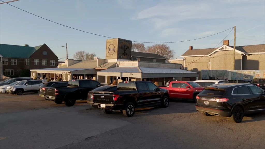 Germantown Pub exterior with prominent sign, patio, and full parking lot.