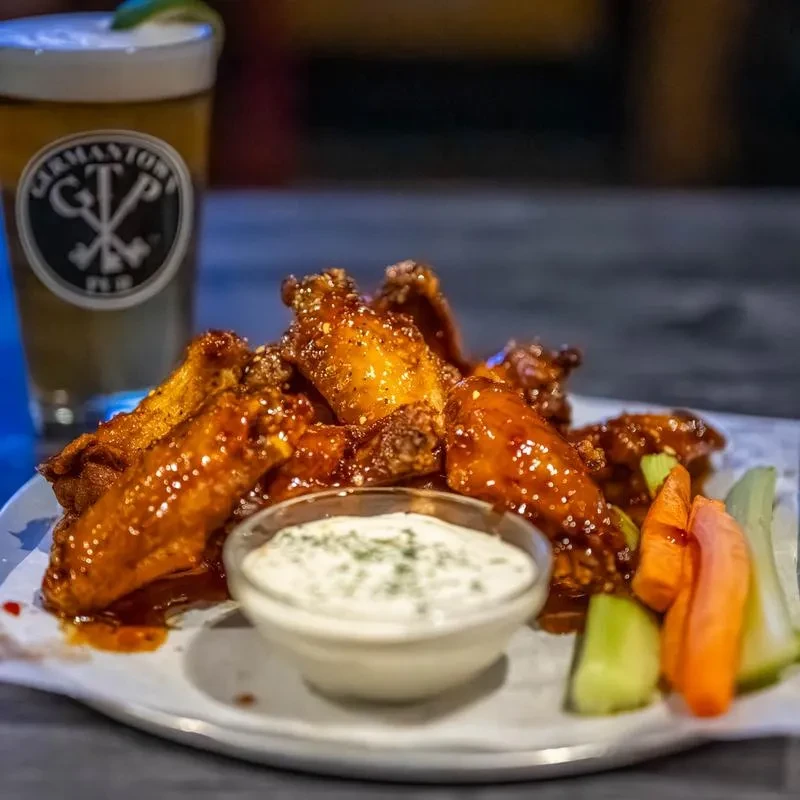 Crispy glazed chicken wings, dip, veggies, and Germantown Pub beer.