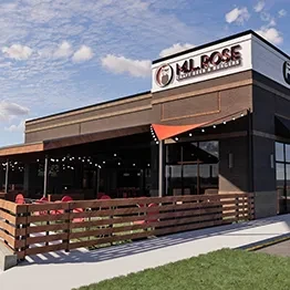 MJ. ROSE CRAFT BEER & BURGERS, modern building with string-lit patio.