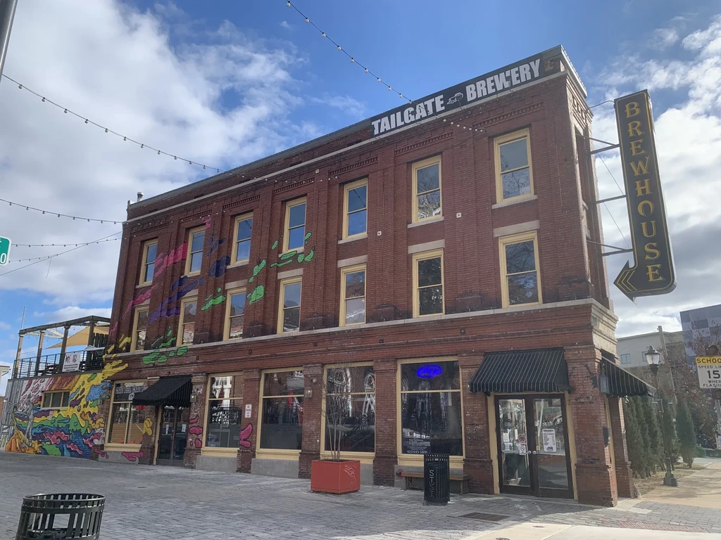 Tailgate Brewery: red brick building with "Brewhouse" sign and street art.