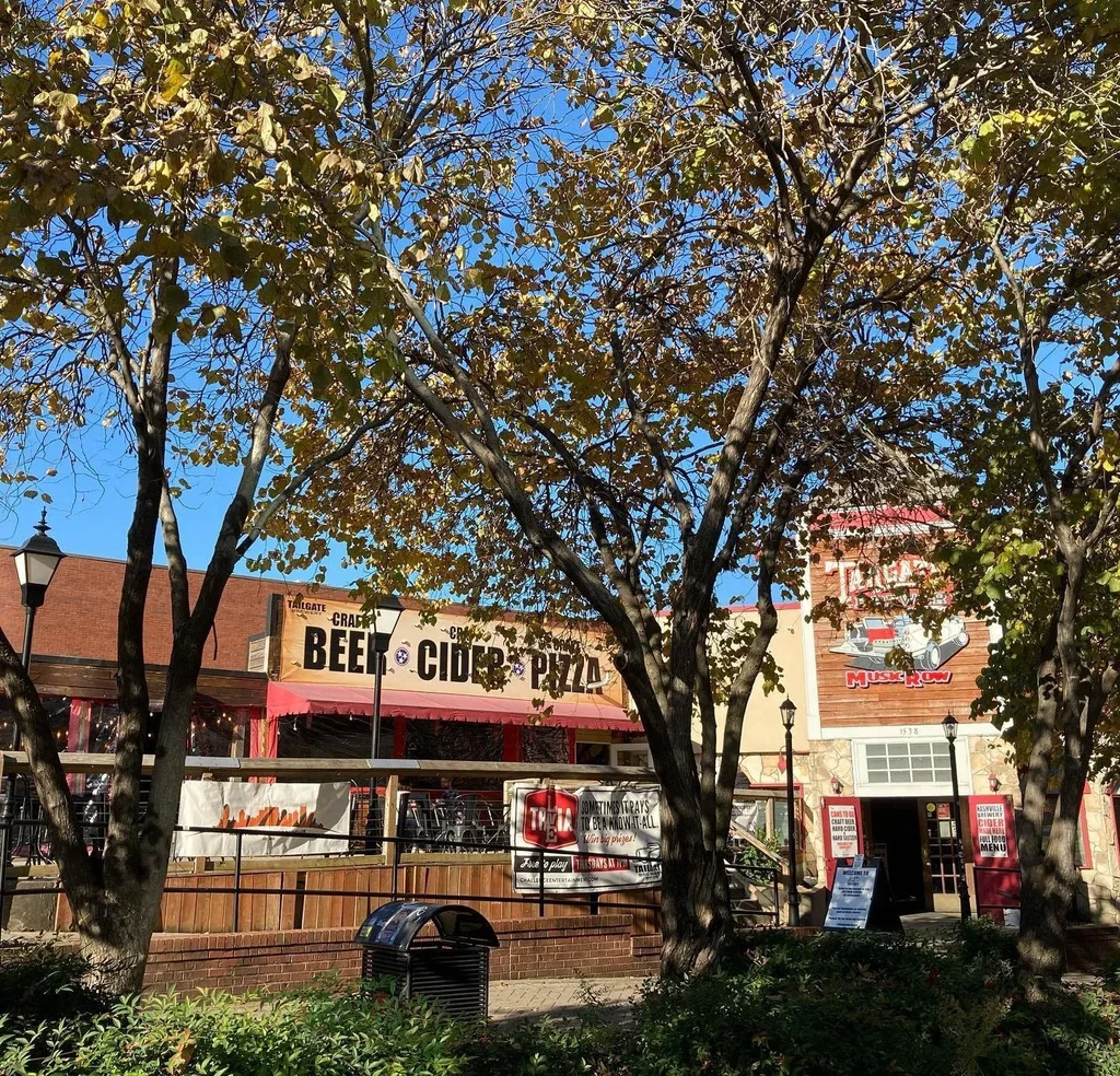 Tailgate Craft Beer and Music Row buildings with autumn trees.