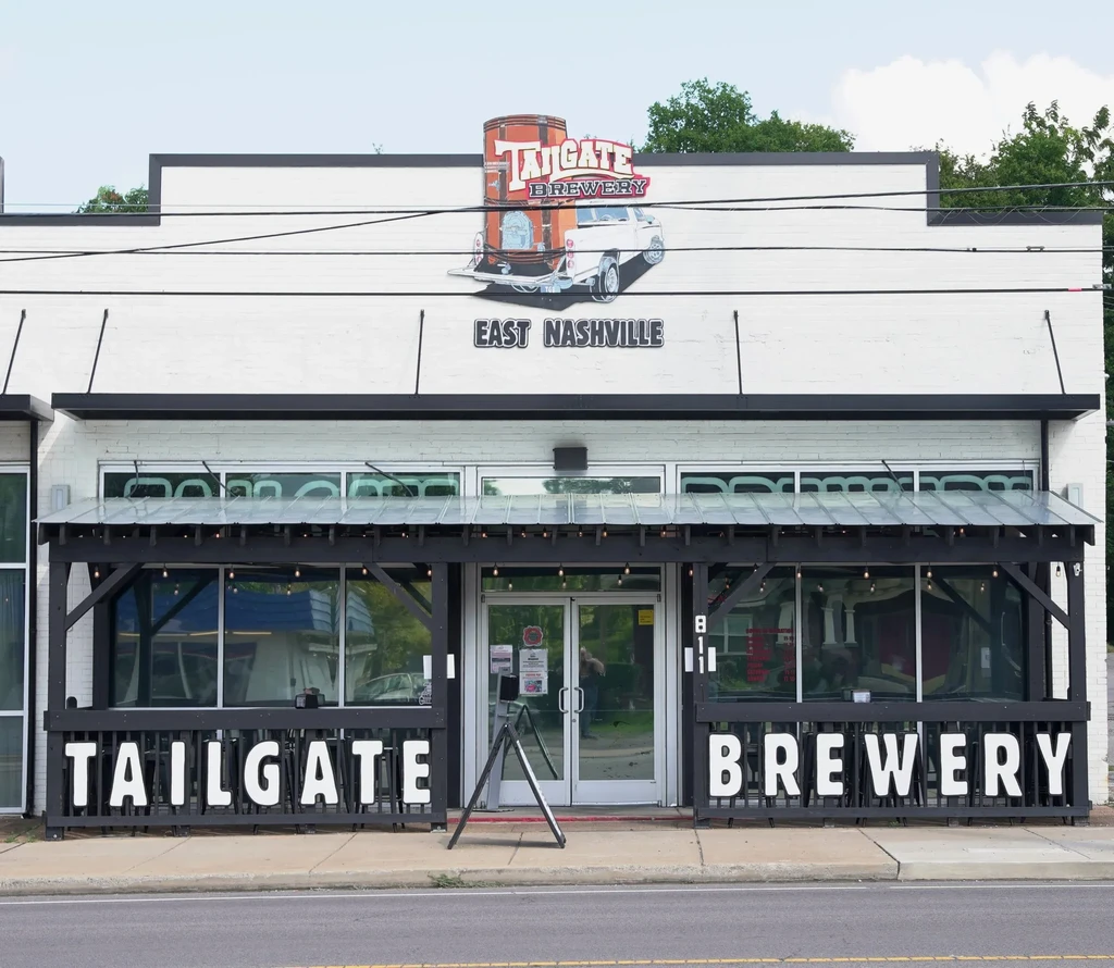 Exterior of Tailgate Brewery, East Nashville, with patio and prominent logo.