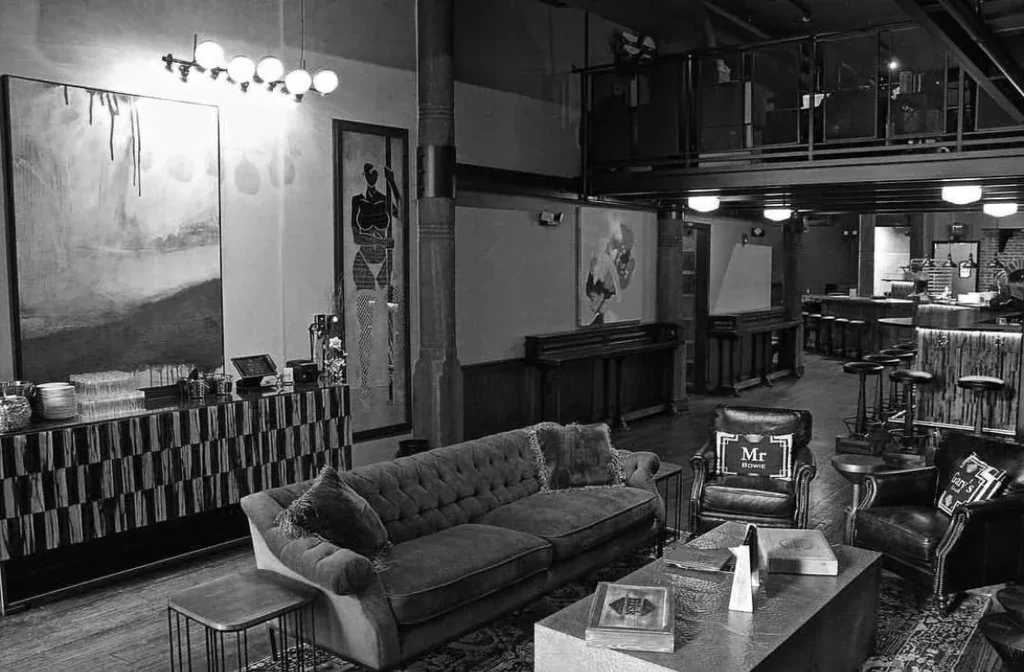 Black and white photo of a sophisticated multi-level lounge bar.