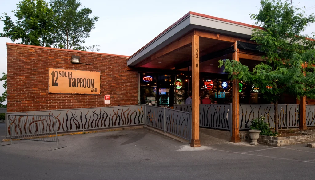 Exterior of 12 SOUTH TAPROOM & GRILL with a covered patio at dusk.