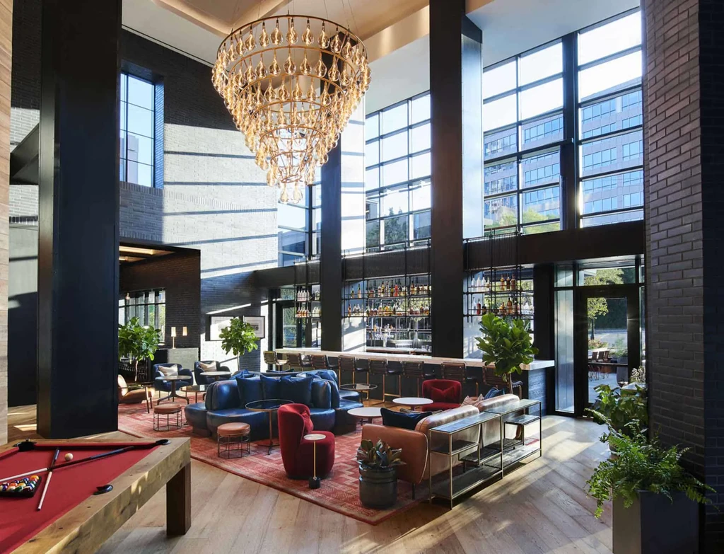 Luxurious lounge bar with grand chandelier, pool table, and stylish seating.