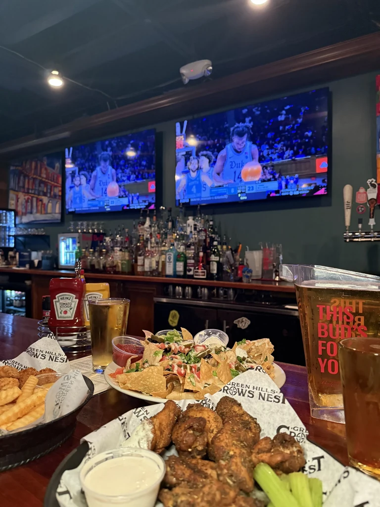 Sports bar: wings, fries, nachos, beer, and basketball on TV.