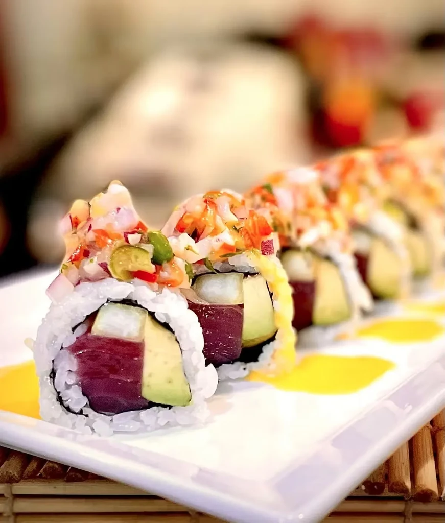 Tuna and avocado sushi rolls with vibrant pico de gallo topping.