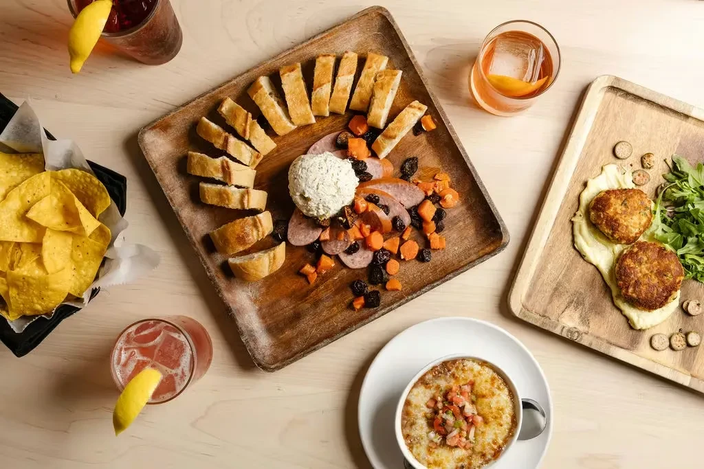 Flat-lay of a table laden with diverse food dishes and drinks.