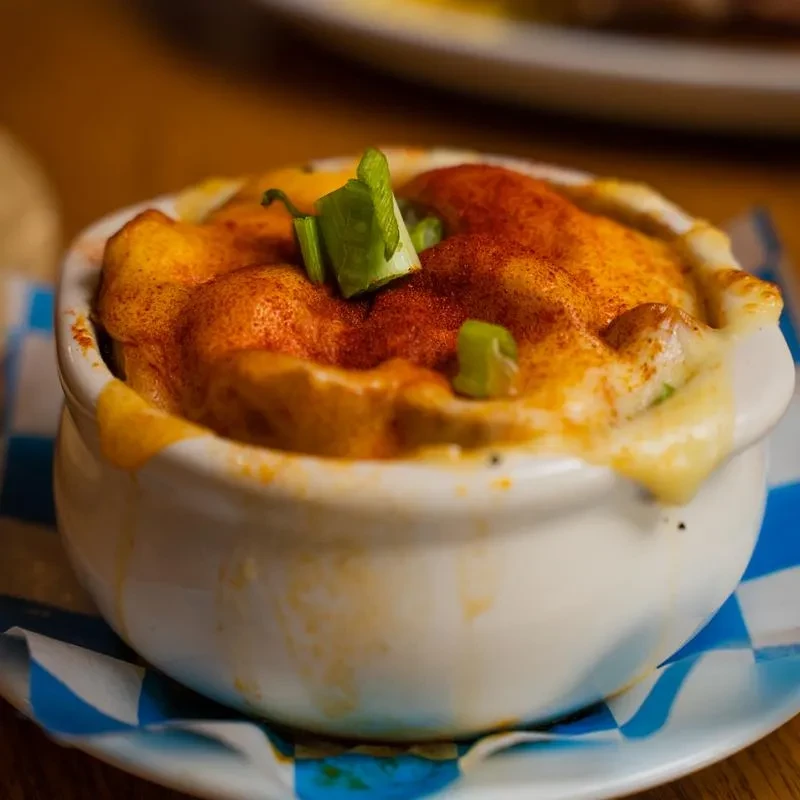 Creamy, golden gratin or mac and cheese topped with paprika and chives.