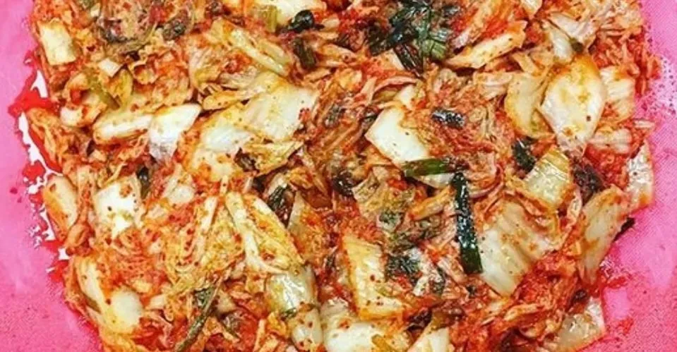 Close-up of traditional Korean kimchi with red cabbage and chili paste.