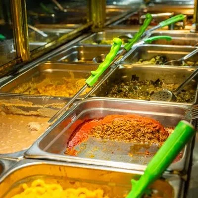 Steam table with self-serve chili, greens, and macaroni and cheese.