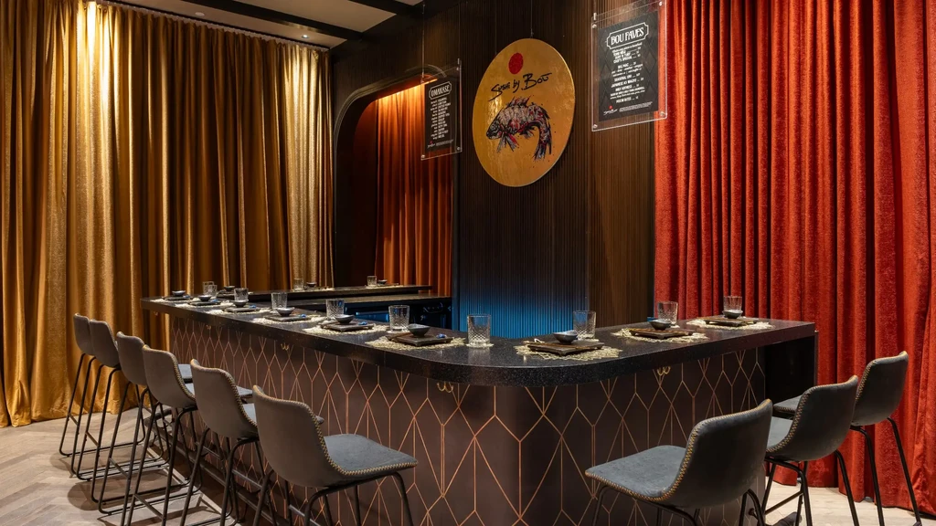 Elegant bar with curved counter, velvet curtains, and menu panels.