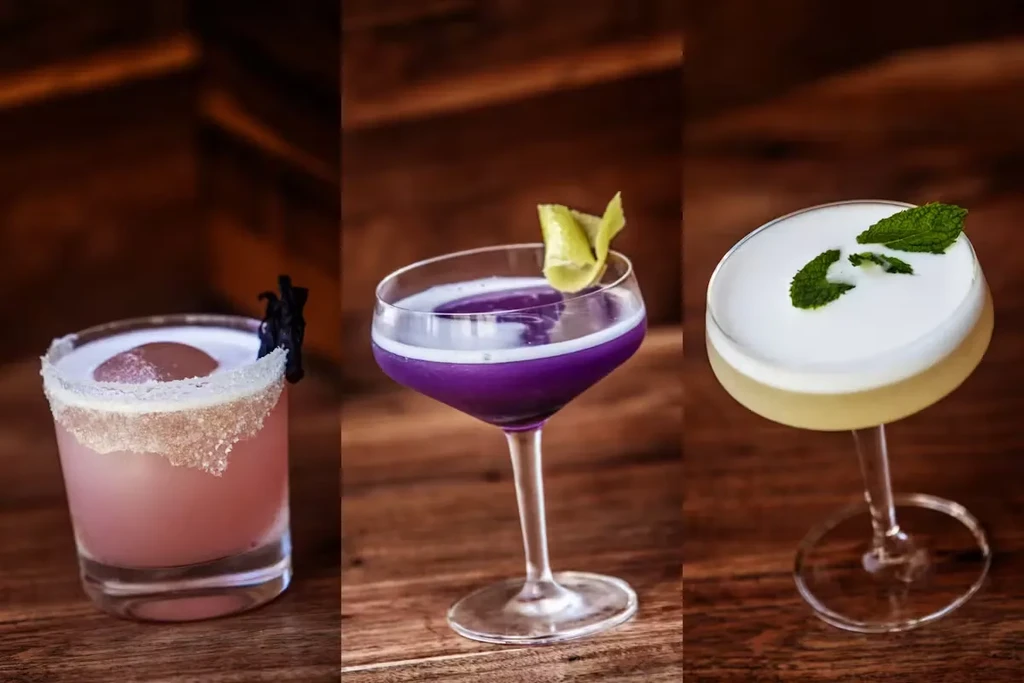 Three different cocktails on a wooden surface.