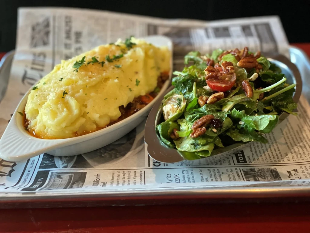 Shepherd's pie with mashed potatoes and a side salad.