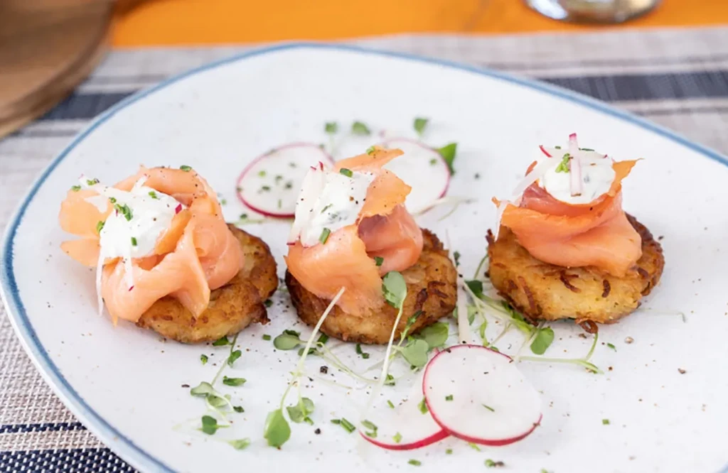 Potato latkes topped with smoked salmon, sour cream, and radish.